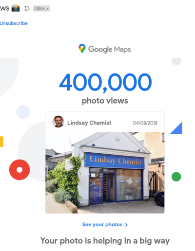 A Google Maps notification showing Lindsay Chemist's photo reaching 400,000 views, featuring an exterior shot of the pharmacy dated 04/08/2018